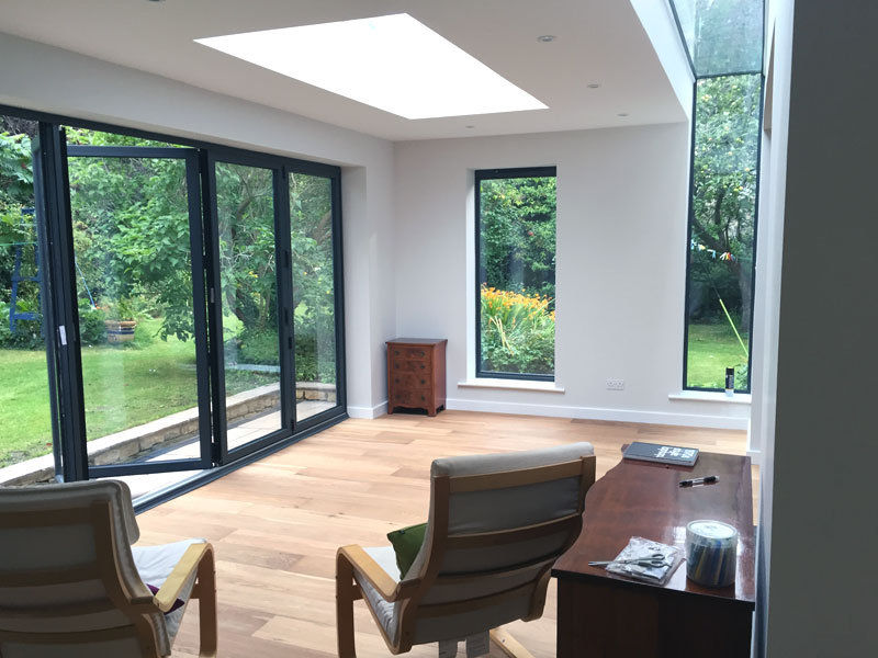 Extension in Winsley built of Farmington natural stone with engineered oak flooring, underfloor heating, aluminium windows and an EPDM flat roof.